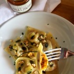 Ravioli ripieni di composta di zucca e zenzero, nocciole e Parmigiano con semi di zucca e zenzero candito